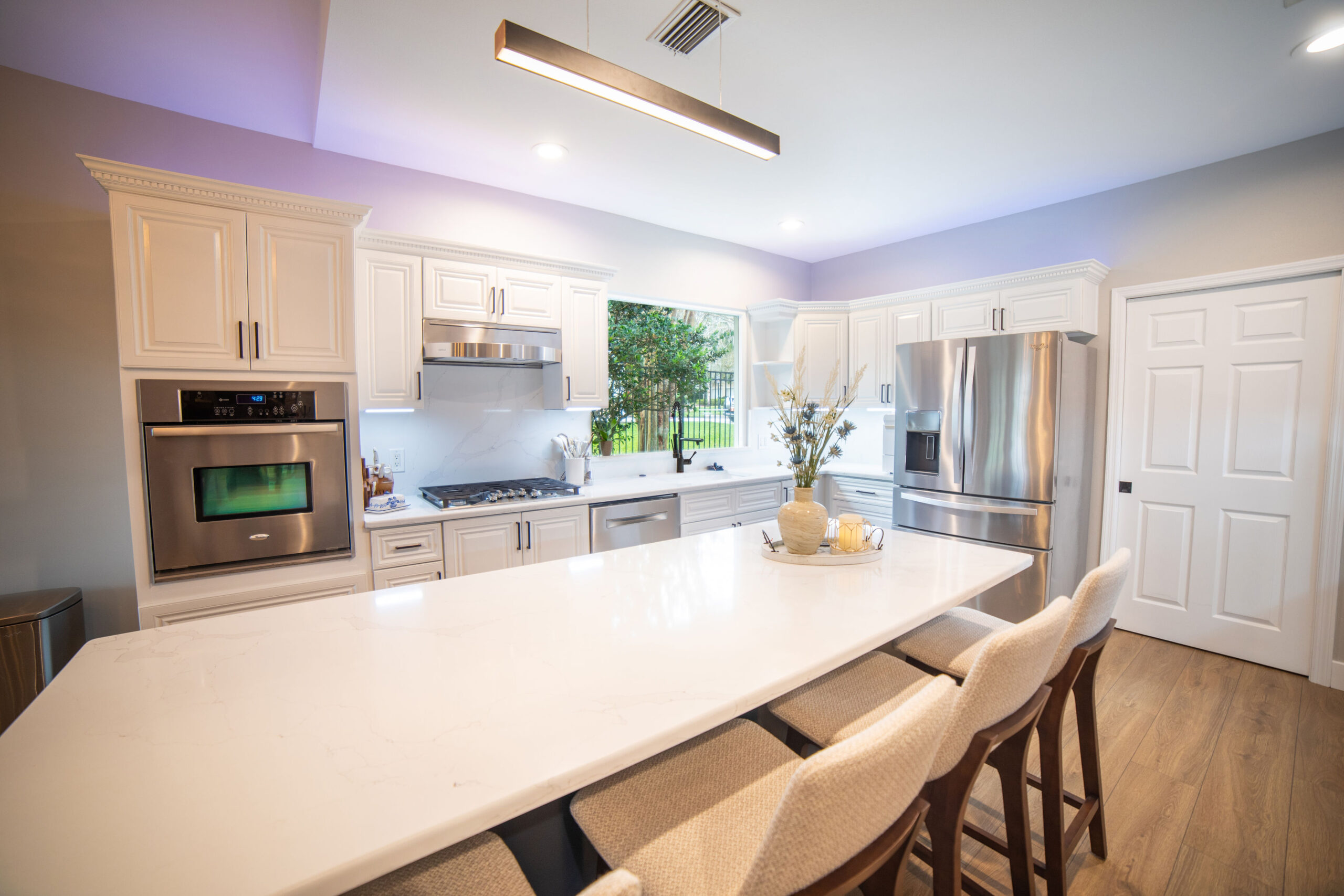 Bright kitchen with a wide island and upholstered seating
