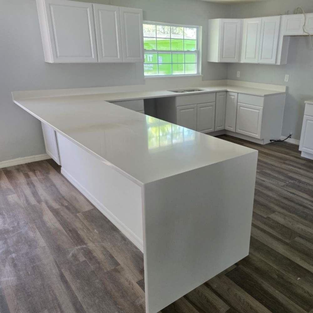 Light countertop extending down a waterfall end